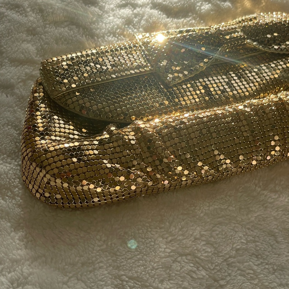 Gold sequence hand feminine mini clutch typically worn for New Year’s, Christmas